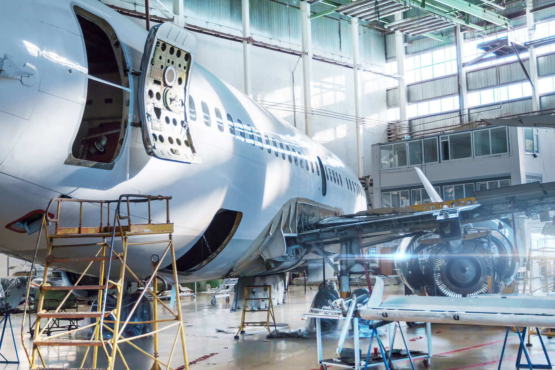 passenger-jet-plane-maintenance-hangar-checking-mechanical-systems-flight-operations-close-up-view-back-aircraft-with-door-open